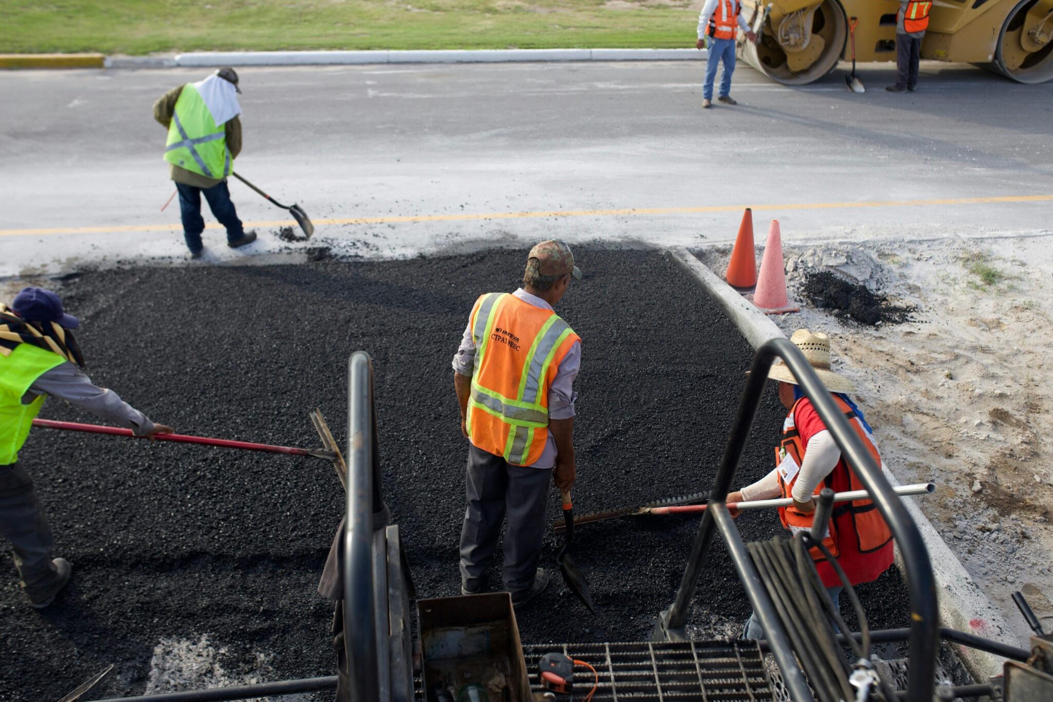 Road construction crew laying asphalt
