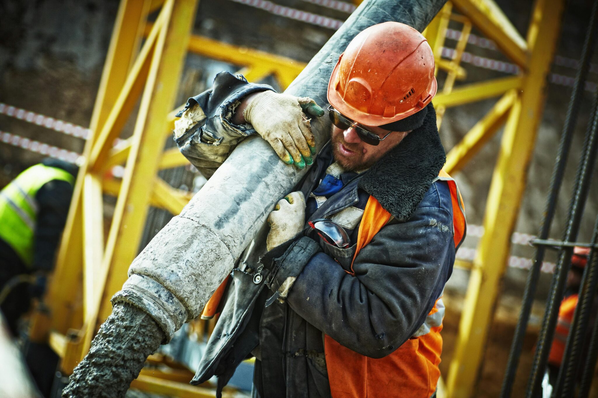 Construction worker pouring concrete on site