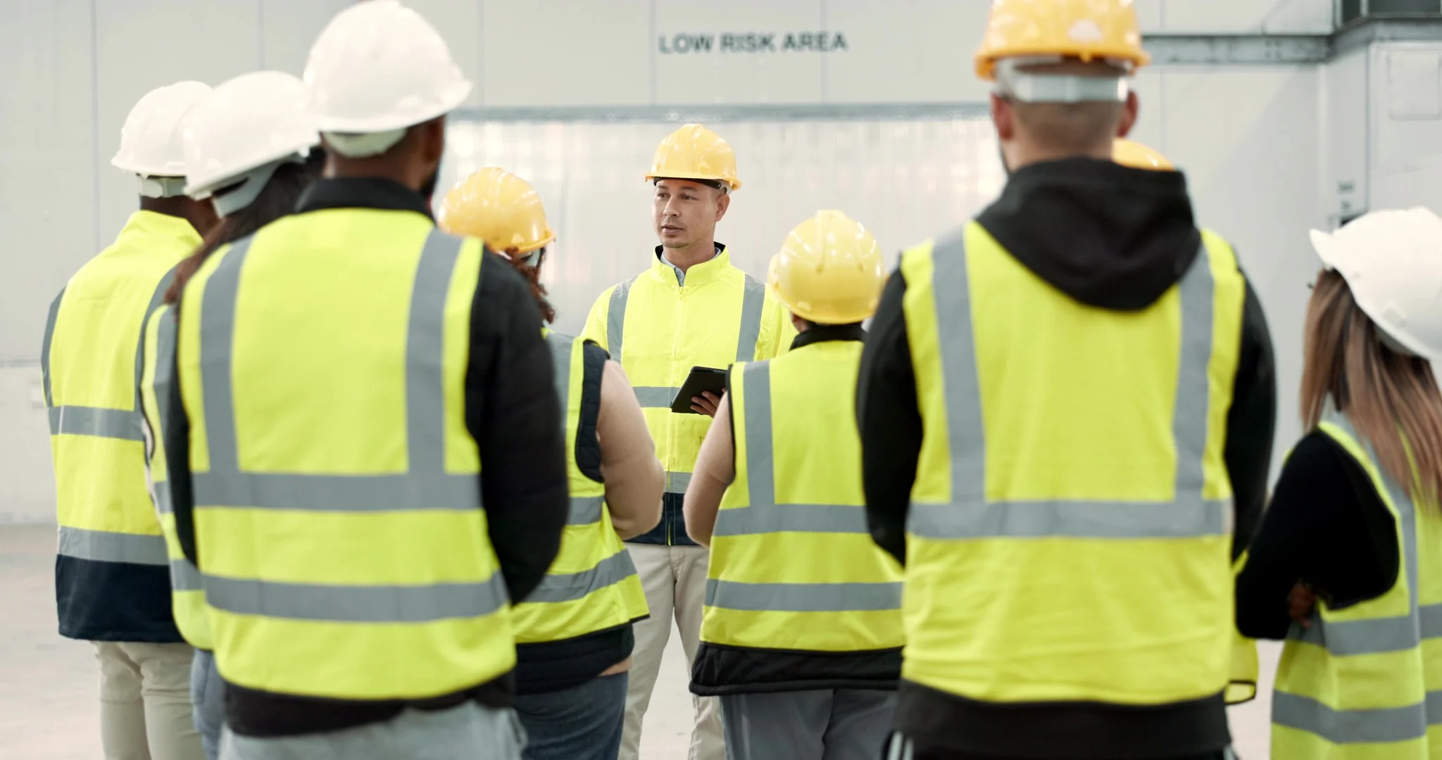 Safety briefing with construction workers in high-vis vests