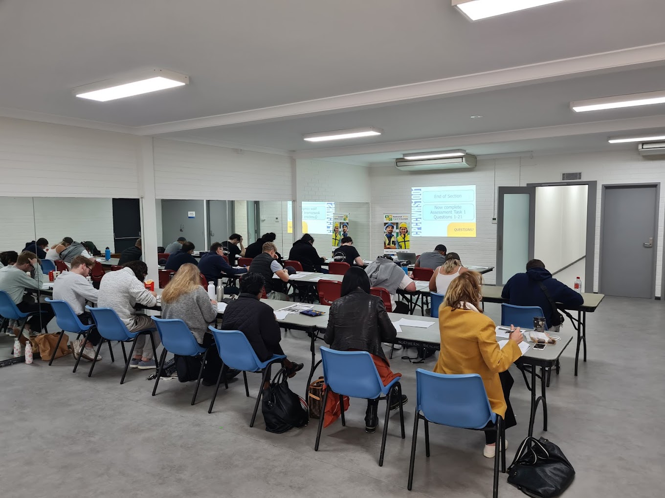 Classroom of students completing White Card training assessments