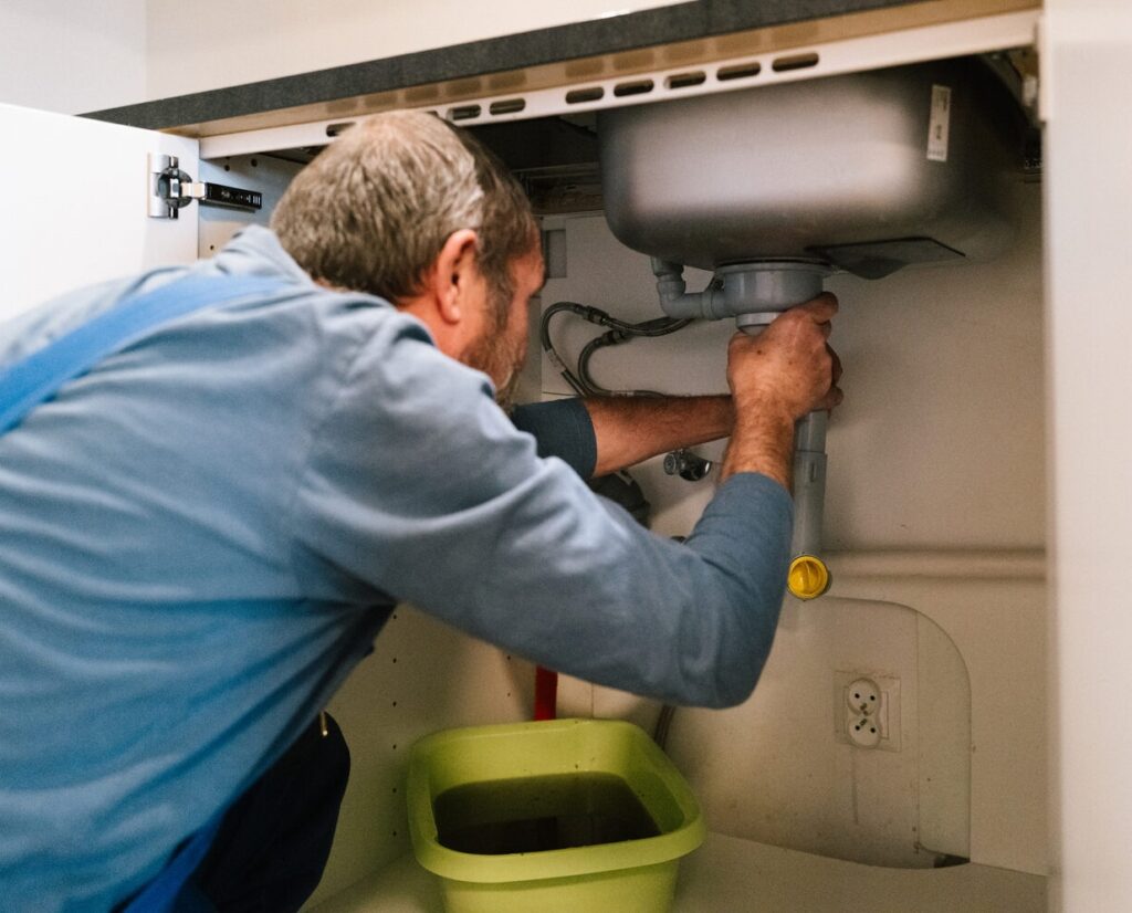 plumber fixing a sink in Australia