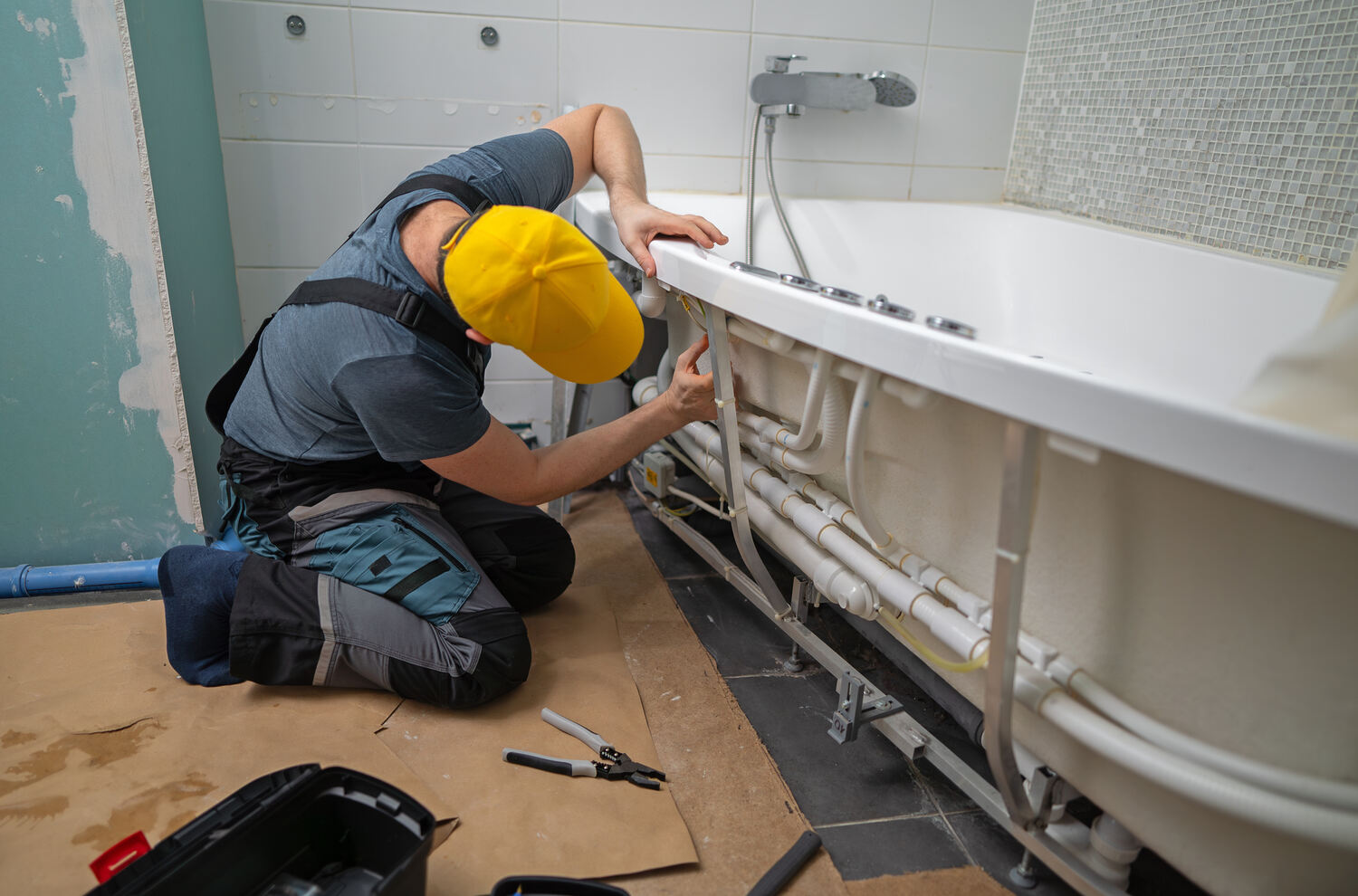 plumber installing a bathtub